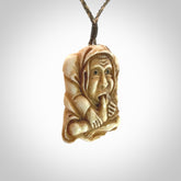 Hand carved incredible stained bone gargoyle face carving. A stunning work of art. This pendant was hand carved in bone with buffalo horn inlay for the eyes by Yuri Terenyi. A one off collectors item that has been hand crafted to be worn or displayed.